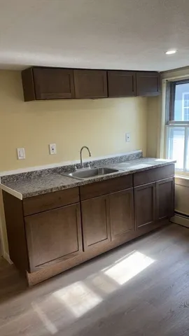 a kitchen with a sink and cabinets