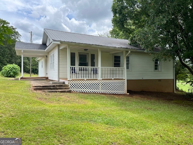 a view of a house with a backyard and a garden