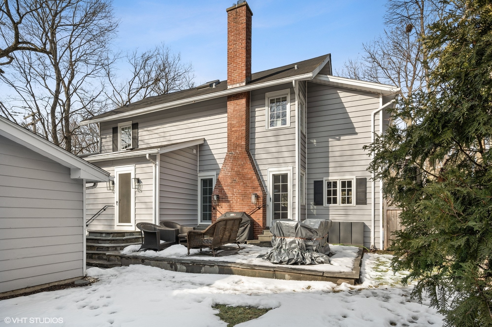 402 Willow Road Winnetka, IL 60093 - Photo 24 of 31 a front view of a house with two chairs and a tree