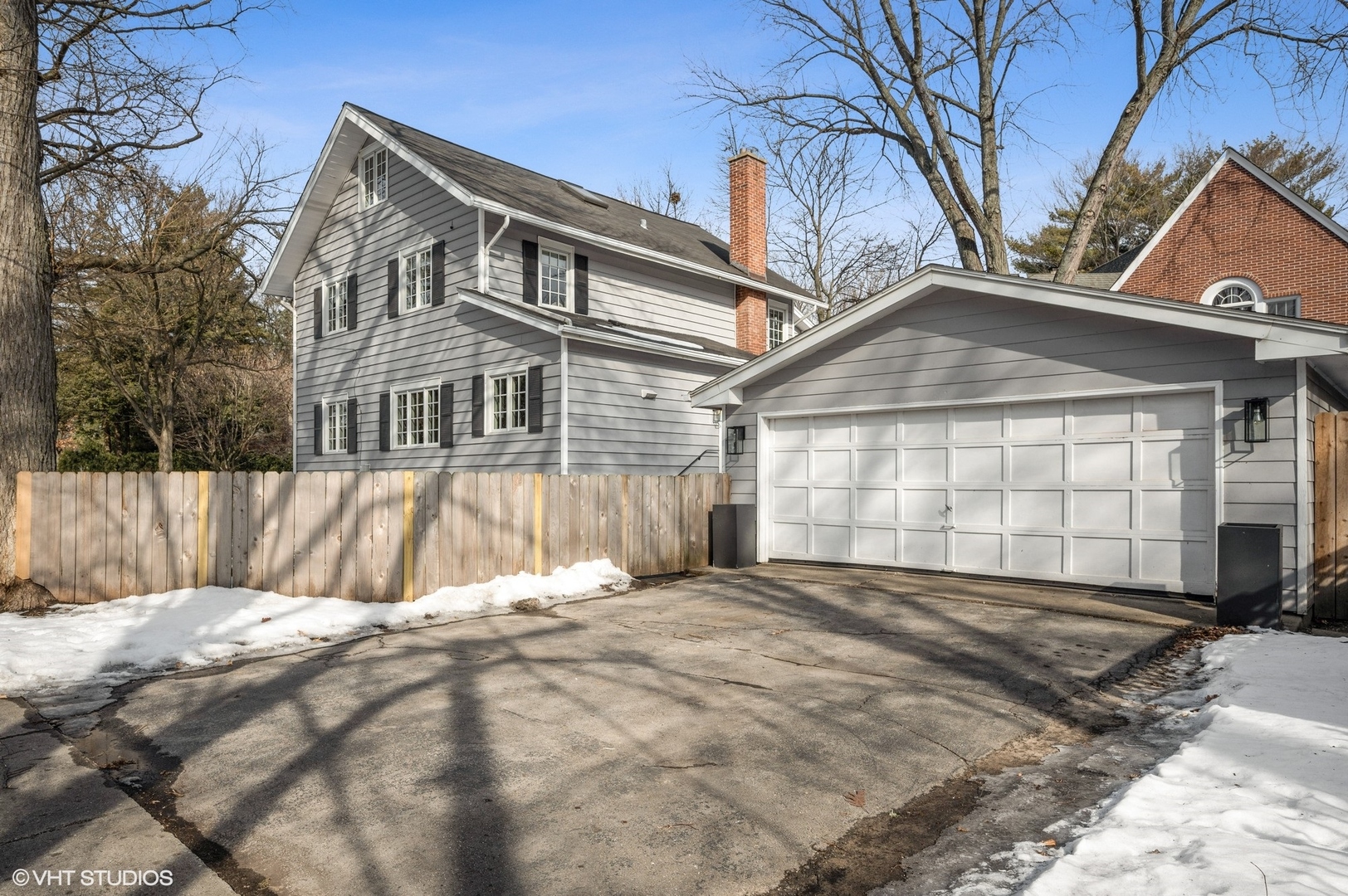 402 Willow Road Winnetka, IL 60093 - Photo 26 of 31 a view of a house with a wooden fence