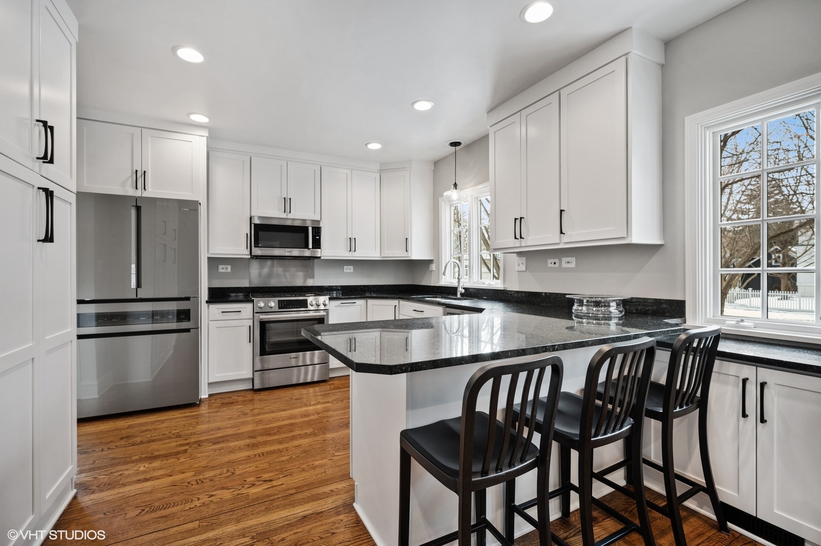 402 Willow Road Winnetka, IL 60093 - Photo 8 of 31 a kitchen with stainless steel appliances granite countertop a stove a sink a microwave and a refrigerator
