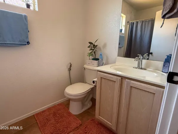 a bathroom with a sink toilet and mirror