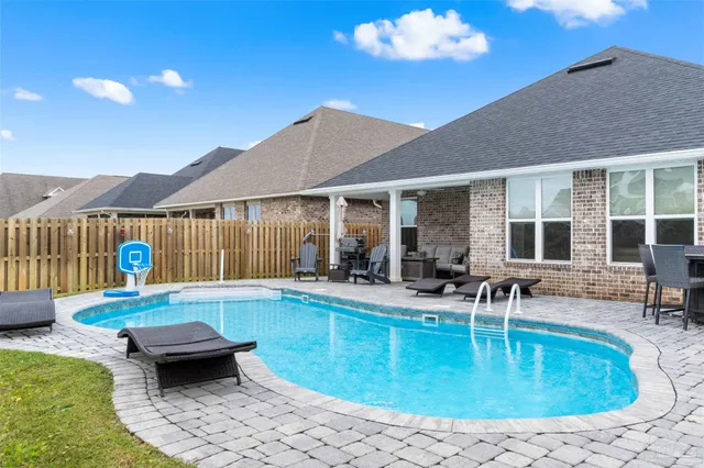 a swimming pool view with a seating space