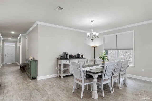 a view of a dining room with furniture and chandelier