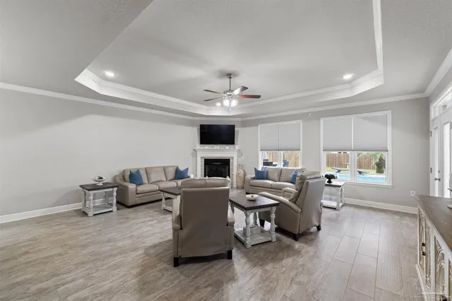 a living room with fireplace furniture and a wooden floor