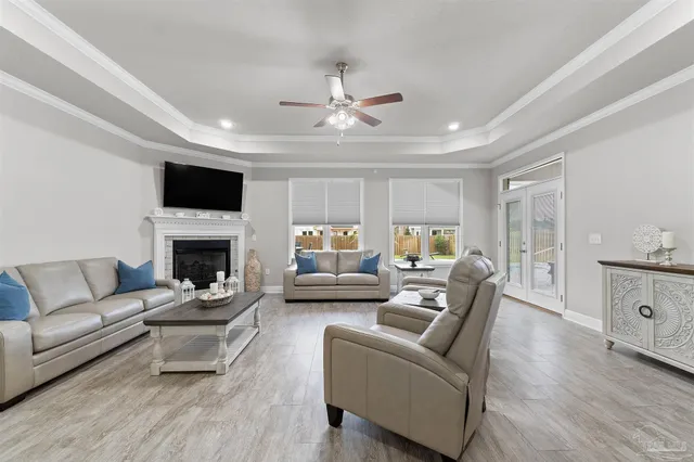 a living room with furniture a fireplace and a flat screen tv