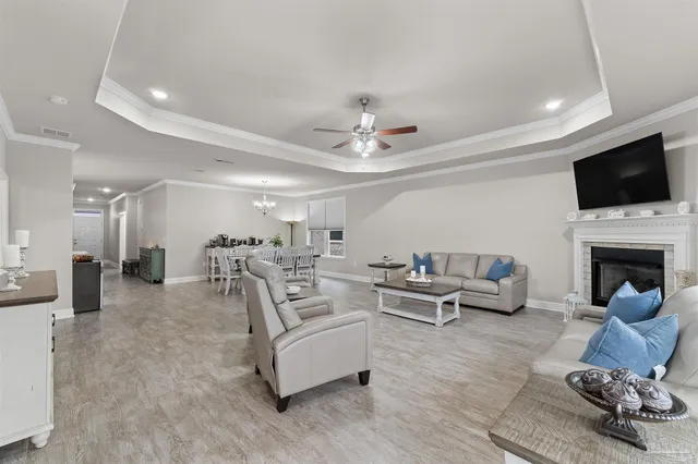 a living room with furniture a fireplace and a flat screen tv
