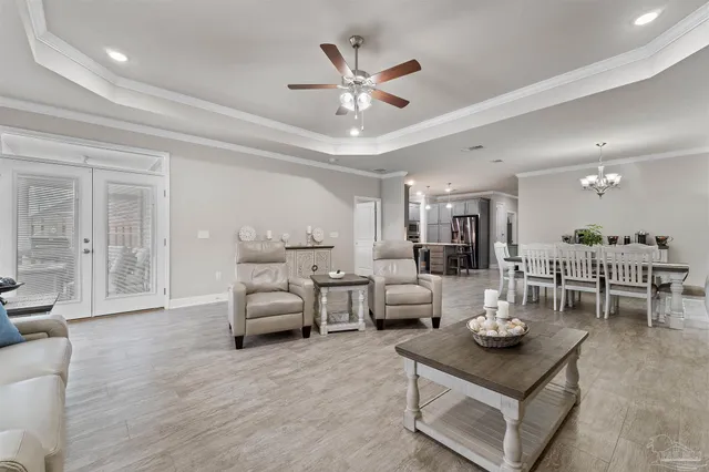 a living room with furniture and view of kitchen