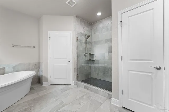 a bathroom with a bathtub and a shower