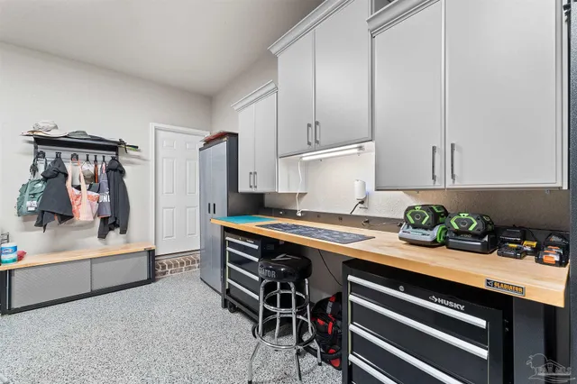 a view of kitchen with stainless steel appliances stove refrigerator and cabinets