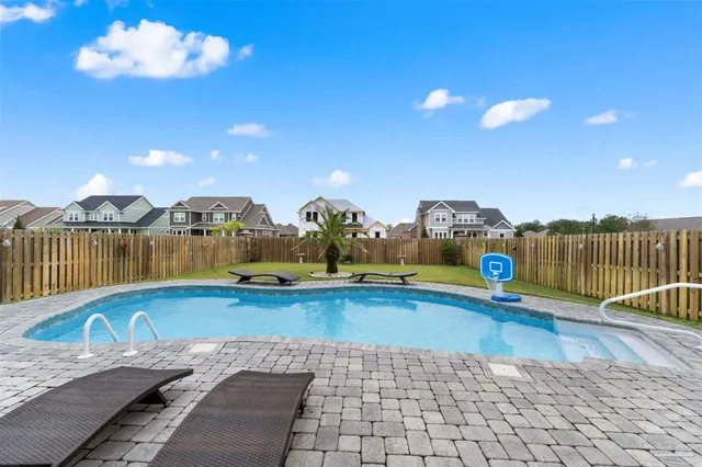 a view of a swimming pool and lounge chairs
