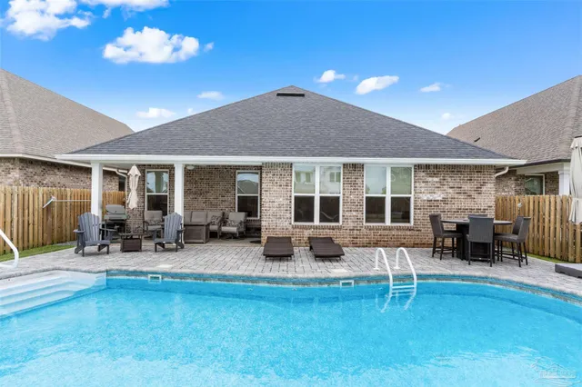 a view of a house with backyard porch and sitting area
