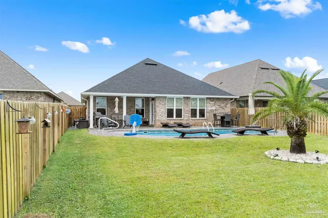 a view of a house with swimming pool and porch