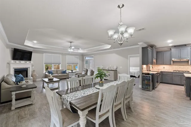 a view of a dining room with furniture wooden floor and a chandelier