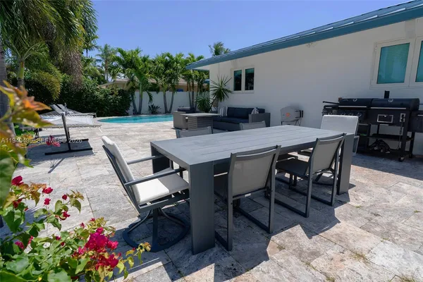 a view of backyard of a house with seating space