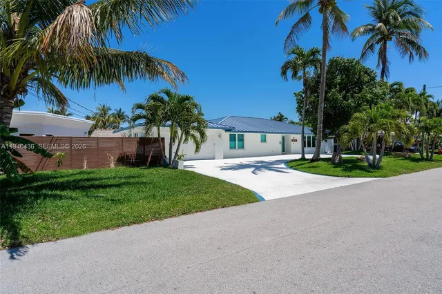 a house with palm tree in front of it