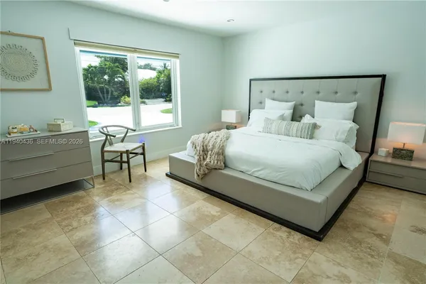 a bedroom with a bed and glass windows