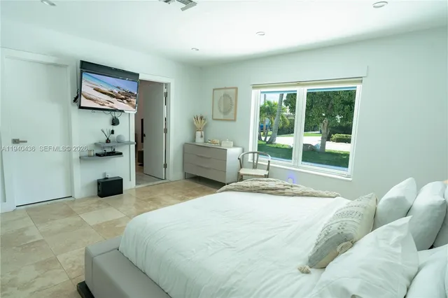 a bedroom with a bed and lamp