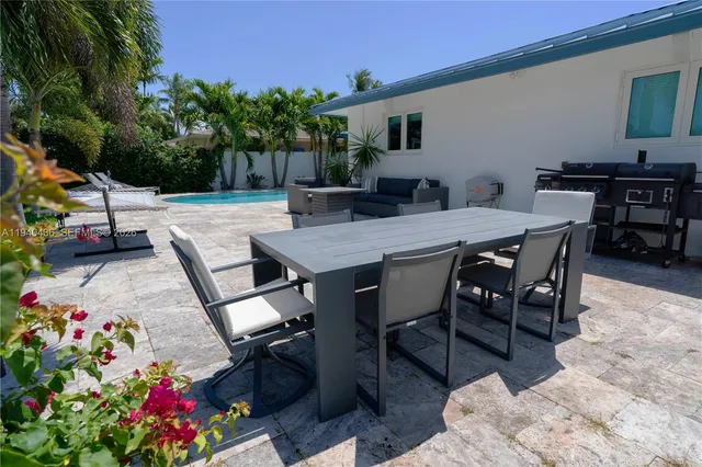 a view of a house with swimming pool and sitting area