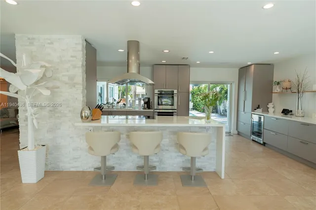 a kitchen with stainless steel appliances a sink a counter top space cabinets and a potted plant