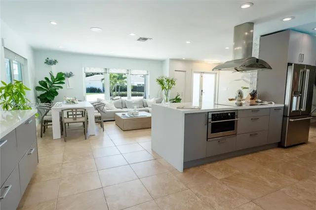 a kitchen with stainless steel appliances a sink a stove and a refrigerator