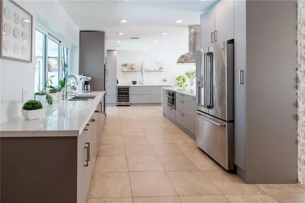 a kitchen with stainless steel appliances kitchen island granite countertop a sink and cabinets
