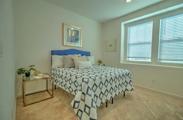 a bedroom with a bed and a window