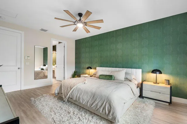 a bedroom with a bed and a chandelier