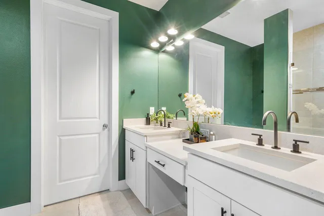 a bathroom with a sink vanity and a mirror