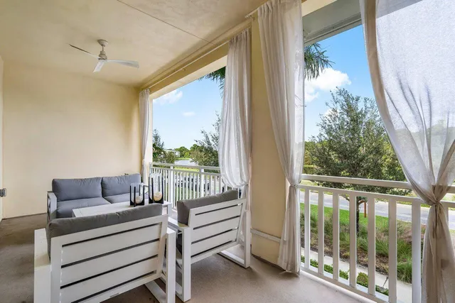 a bedroom with furniture and a large window