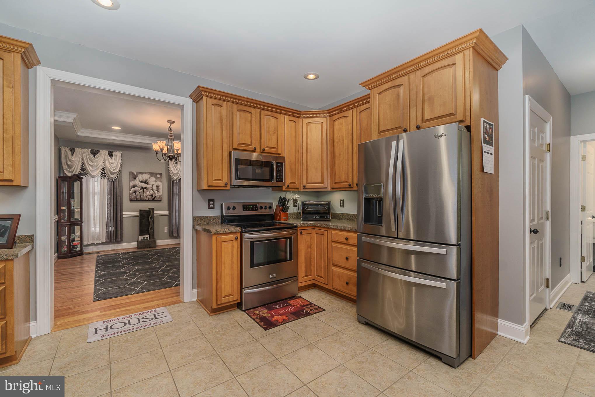 2375 Carrollton Road Westminster, MD 21157 - Photo 11 of 37 a kitchen with granite countertop a refrigerator and a stove top oven