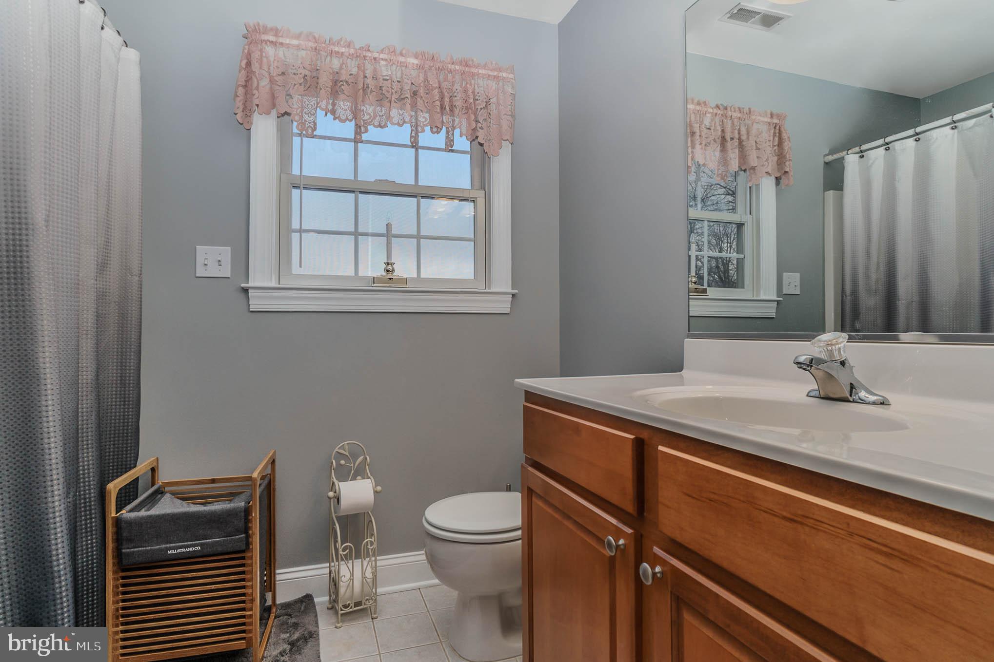 2375 Carrollton Road Westminster, MD 21157 - Photo 26 of 37 a bathroom with a granite countertop toilet sink and mirror