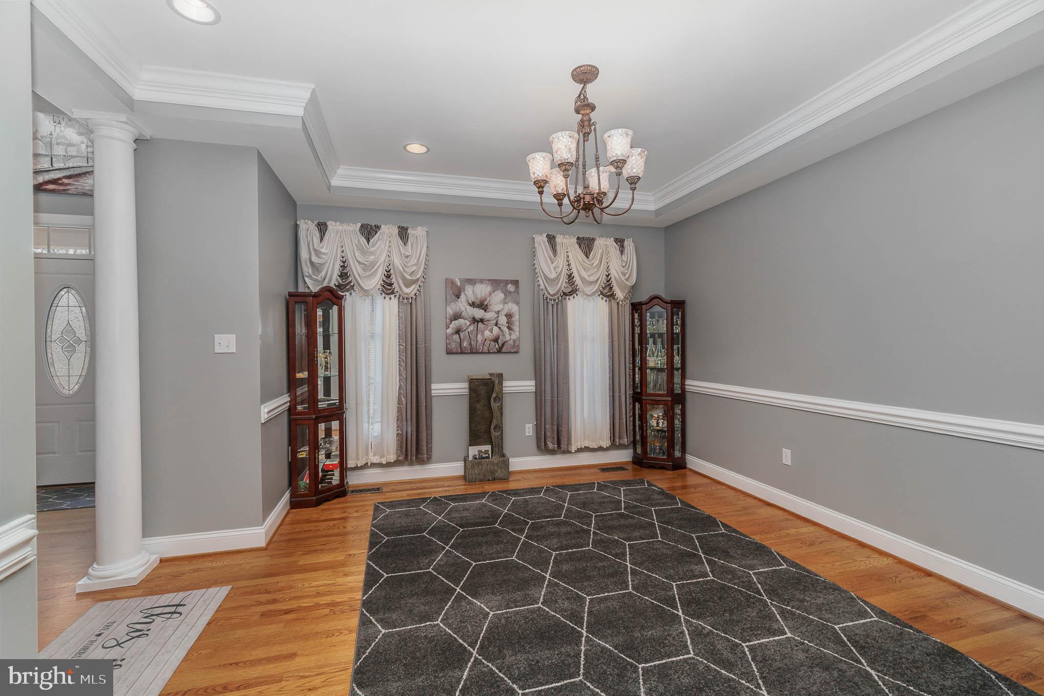2375 Carrollton Road Westminster, MD 21157 - Photo 7 of 37 a view of a hallway with wooden floor and chandelier