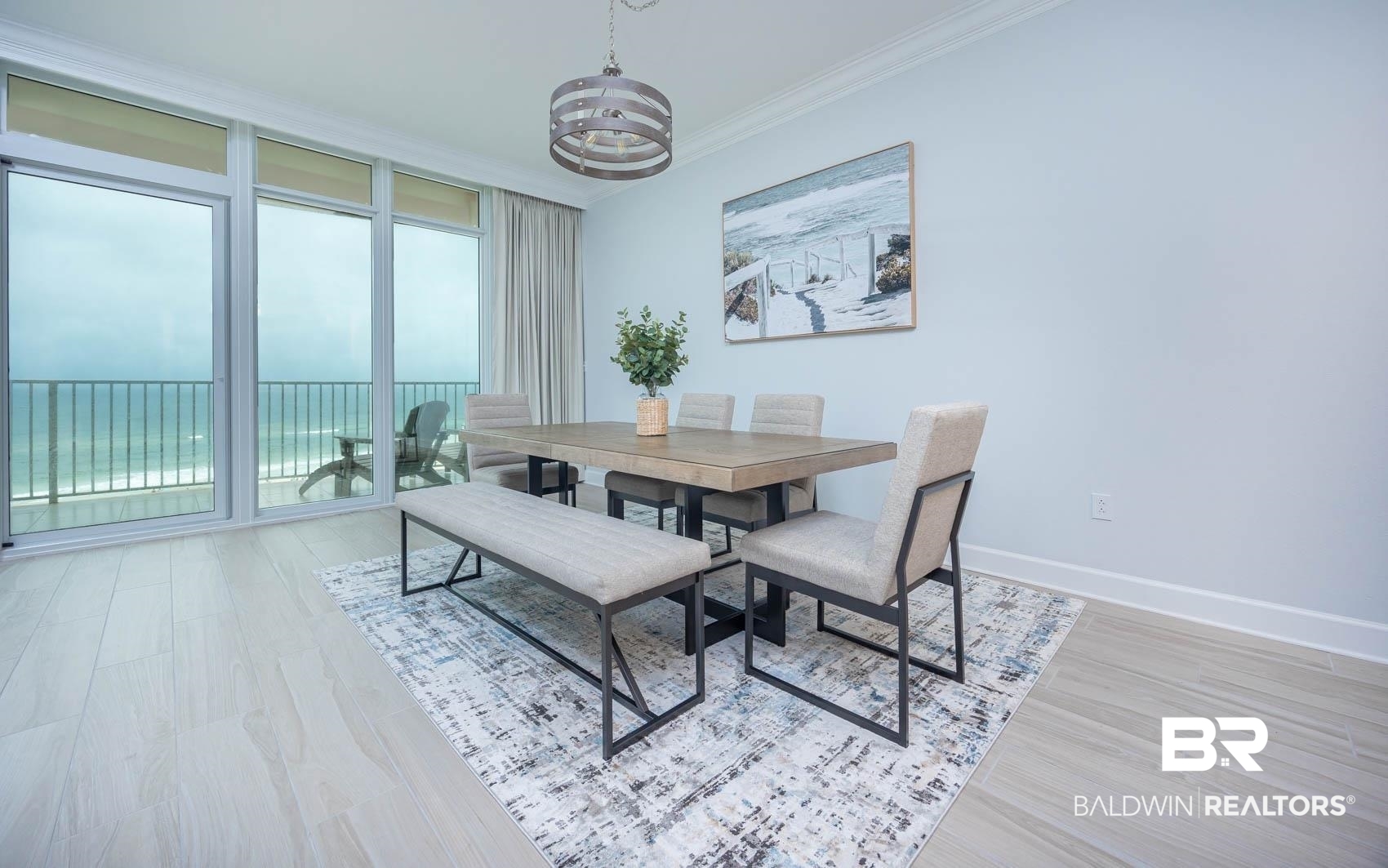 23008 Perdido Beach Boulevard, Unit 506 Orange Beach, AL 36561 - Photo 6 of 48 Dining area with crown molding, baseboards, a notable chandelier, and light wood-type flooring