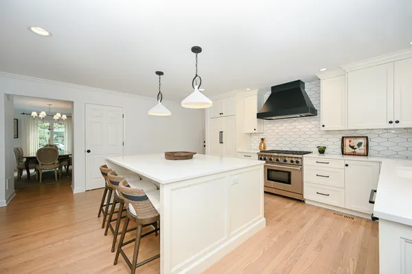 a kitchen with a stove a sink and a refrigerator