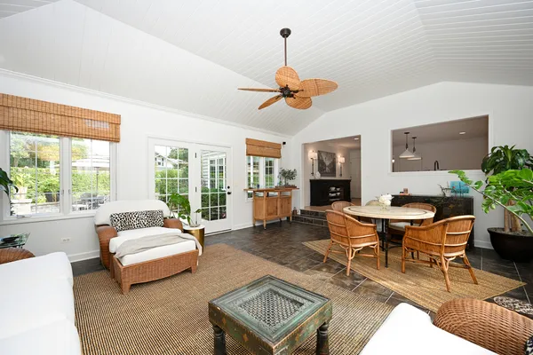 a living room with furniture a window and a chandelier