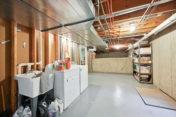 a utility room with multiple dryer and washer
