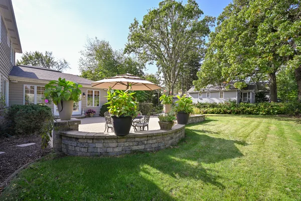 a view of a house with backyard and sitting area