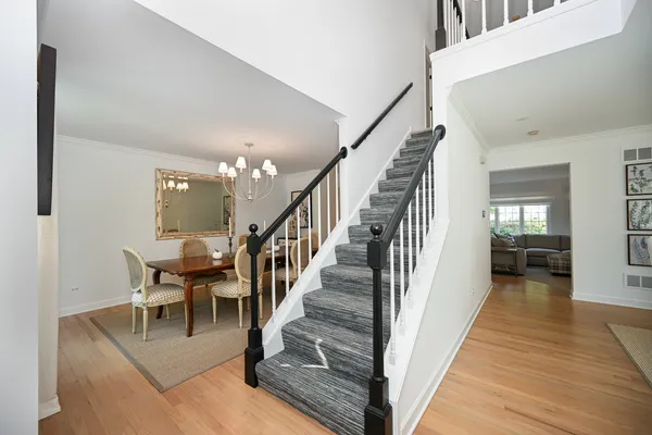 a view of a hallway view with wooden floor and staircase