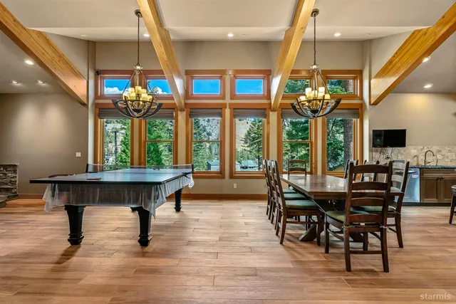 a kitchen with stainless steel appliances granite countertop a sink a stove and a wooden cabinets