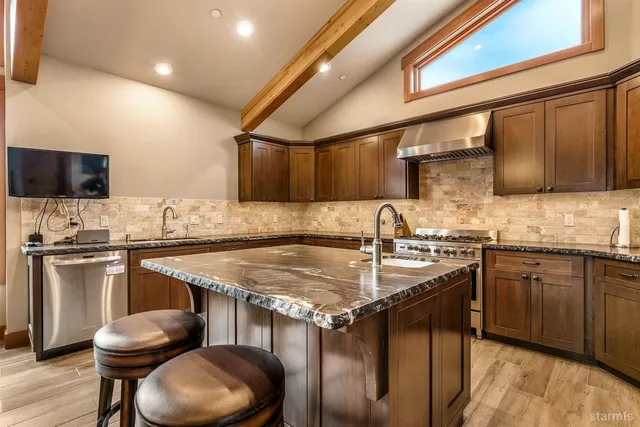 a living room with furniture and large windows