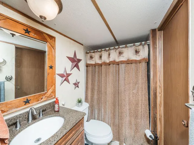 a bedroom with a bed and a mirror