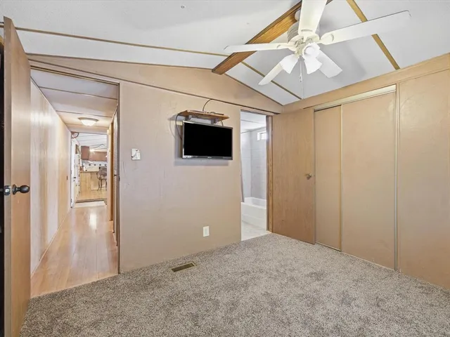 a bathroom with a granite countertop sink toilet a mirror and shower