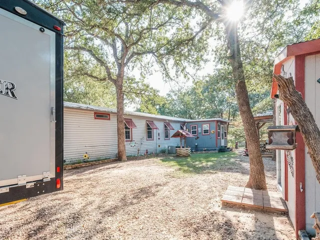 a view of a house with wooden fence