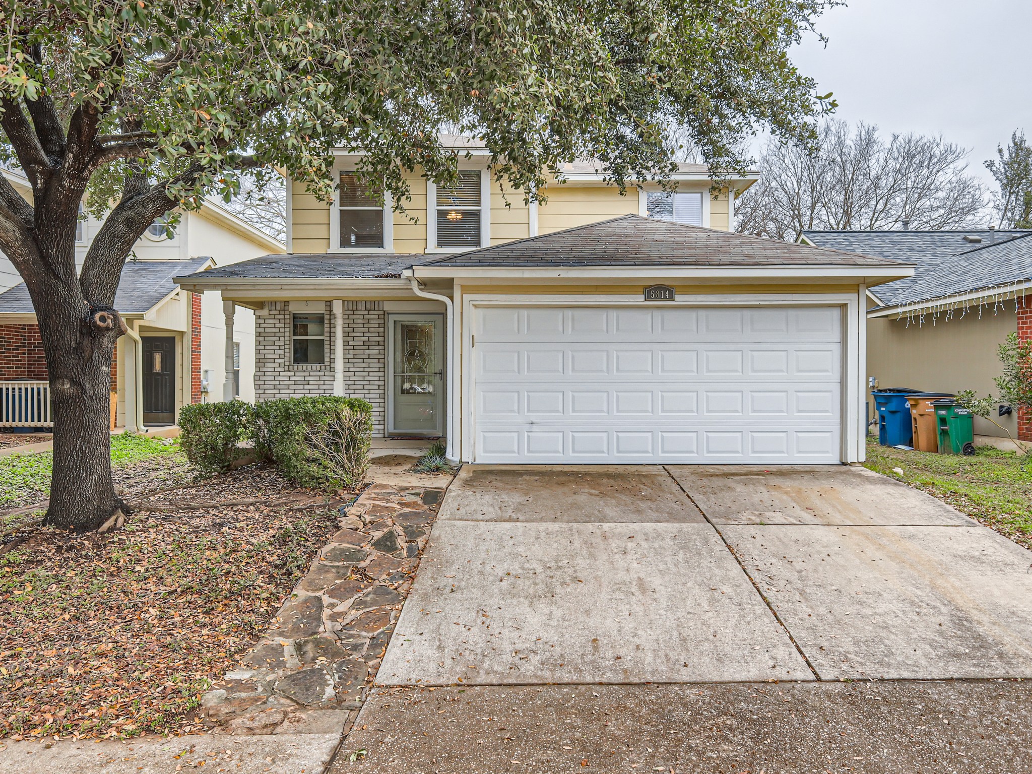 5814 Steven Creek Way Austin, TX 78721 - Photo 1 of 15 a front view of a house with a yard and garage