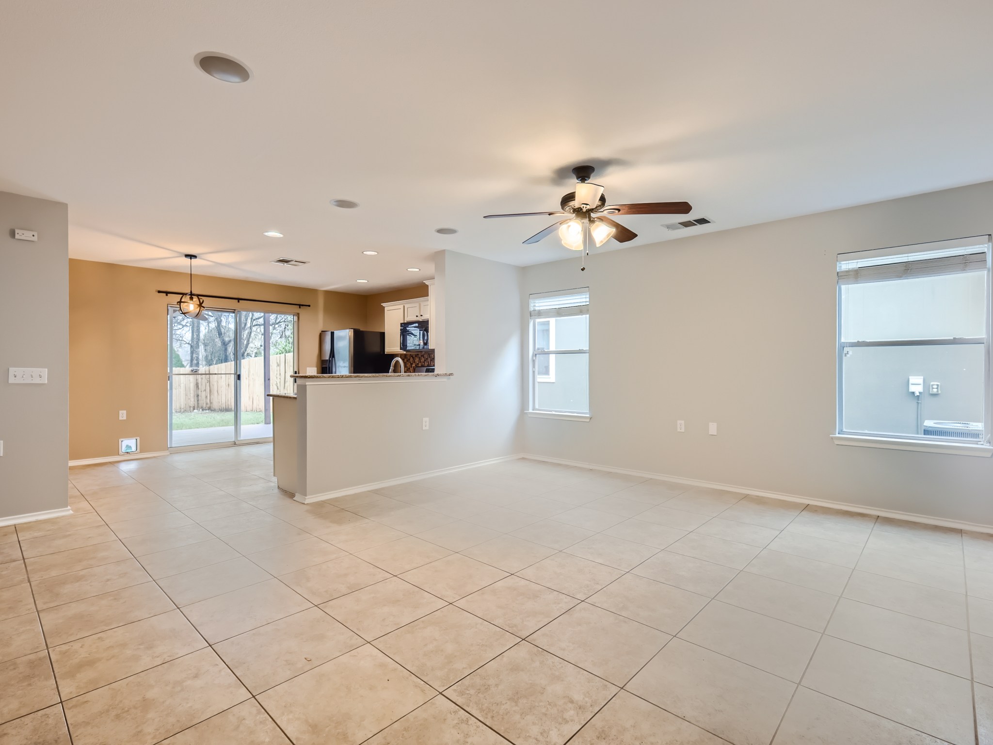 5814 Steven Creek Way Austin, TX 78721 - Photo 2 of 15 a view of a kitchen with furniture and a ceiling fan