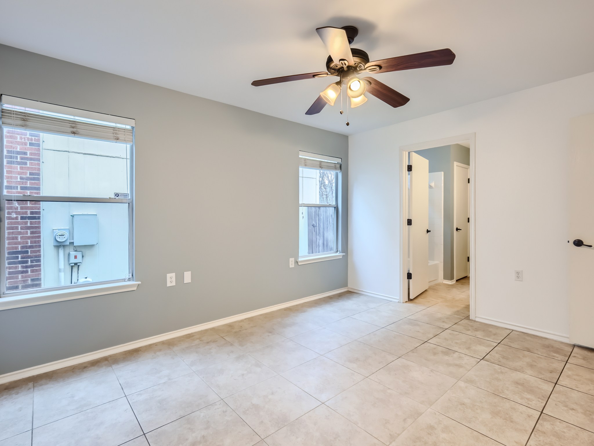 5814 Steven Creek Way Austin, TX 78721 - Photo 4 of 15 a view of an empty room with a ceiling fan and window