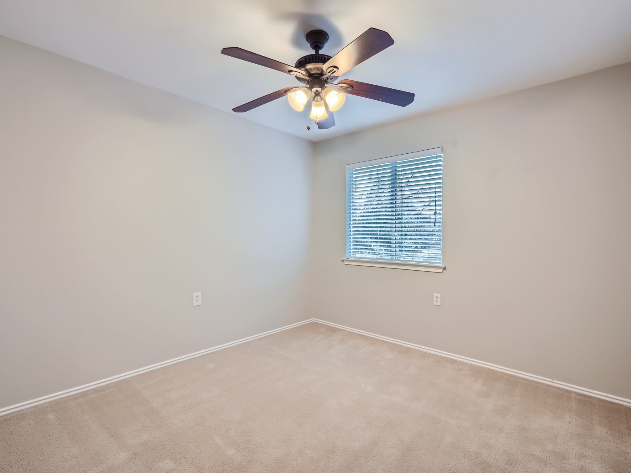 5814 Steven Creek Way Austin, TX 78721 - Photo 7 of 15 an empty room with window and ceiling fan