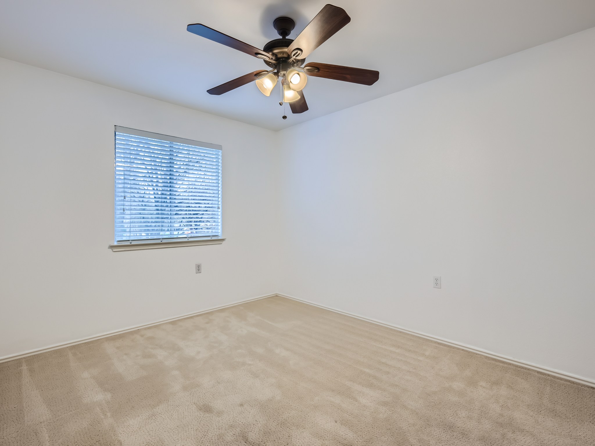 5814 Steven Creek Way Austin, TX 78721 - Photo 9 of 15 an empty room with a window and a ceiling fan