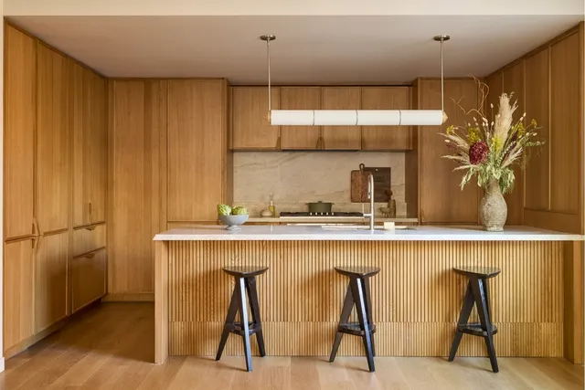 a kitchen with a table chairs refrigerator and sink